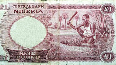 Eski bir Nijeryalı 'nın ters tarafının büyük bir parçası. İçinde tarihi hasat eden bir adam var. Eski bir Nijerya para banknotunun seçici odağı.