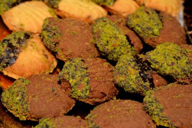 El-Fitr bayramını kutlamak için geleneksel Arap kurabiyeleri yığını, reçel ve fındıkla doldurulmuş ve çikolata ve şam fıstığı ile kaplanmış dört küçük fırın (mignardises).