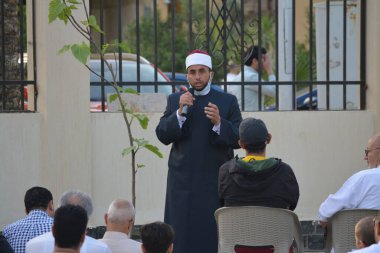 Kahire, Mısır, 2 Mayıs 2022: Bir cami vaizi, yaygınlık yasağı sona erdikten sonra cami yakınlarındaki açık hava sahasında Kurban İmam El Fitr Khutbah 'ı (vaaz) sahneledi, İslami kahvaltı namazı ve kutlama duası yaptı