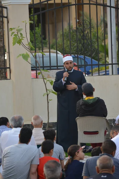 Kahire, Mısır, 2 Mayıs 2022: Bir cami vaizi, yaygınlık yasağı sona erdikten sonra cami yakınlarındaki açık hava sahasında Kurban İmam El Fitr Khutbah 'ı (vaaz) sahneledi, İslami kahvaltı namazı ve kutlama duası yaptı