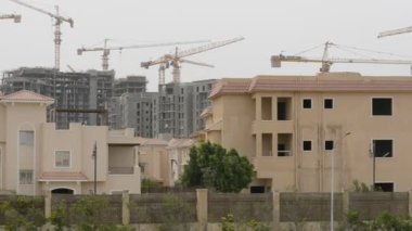 Giza, Mısır, 13 Mayıs 2022: Mısır 'daki yeni binaların inşaatı, Zed şehri Şeyh Zayed şehri, turna kuşları ve seçici odaklı inşaat halindeki konut binaları.