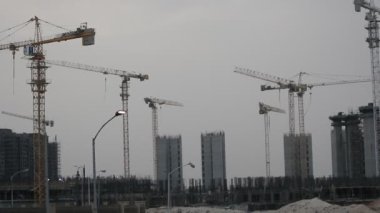 Giza, Egypt, May 13 2022: Construction site of new buildings in Egypt, Zed city Sheikh Zayed city, acres of luxurious real estate residential buildings under construction with cranes, selective focus
