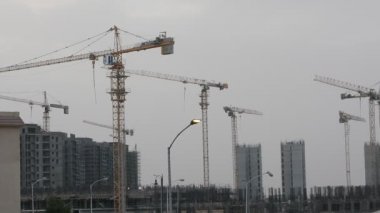 Giza, Egypt, May 13 2022: Construction site of new buildings in Egypt, Zed city Sheikh Zayed city, acres of luxurious real estate residential buildings under construction with cranes, selective focus