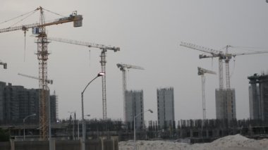 Giza, Egypt, May 13 2022: Construction site of new buildings in Egypt, Zed city Sheikh Zayed city, acres of luxurious real estate residential buildings under construction with cranes, selective focus