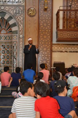 Kahire, Mısır, 31 Mayıs 2022: Cami vaizi İmam, camideki çocuklara yönelik yaz İslami eğitim programı sırasında camide genç Müslüman çocuklara vaaz veriyor.