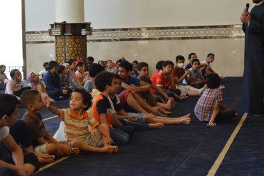 Kahire, Mısır, 31 Mayıs 2022: Cami vaizi İmam, camideki çocuklara yönelik yaz İslami eğitim programı sırasında camide genç Müslüman çocuklara vaaz veriyor.