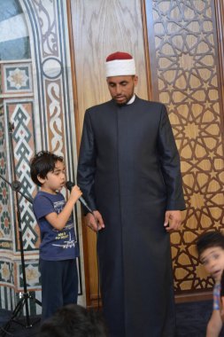 Kahire, Mısır, 31 Mayıs 2022: Cami vaizi İmam, camideki çocuklara yönelik yaz İslami eğitim programı sırasında camide genç Müslüman çocuklara vaaz veriyor.