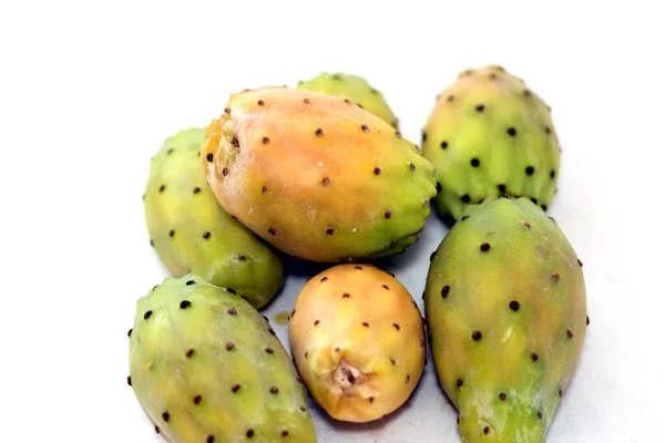 Pile of fresh prickly pear fruit isolated on white background, selective focus, Opuntia, commonly called prickly pear, Barbary fig, tuna fruit, sabra and nopal