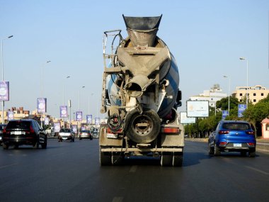 Cairo, Egypt, July 24 2022: A concrete and cement transit mixer lorry truck on its way to deliver concrete to a construction site, it combines cement, aggregate such as sand or gravel, and water