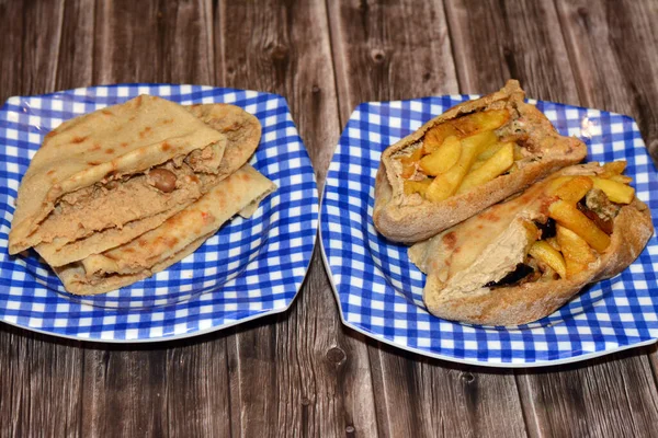 flat breads with mashed fava beans and traditional Egyptian dynamite sandwiches filled with a mixture of fava beans, eggs, Egyptian flafel green burger, potatoes fried fingers, fried aubergine