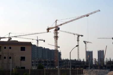 Giza, Egypt, June 6 2022: A construction site of new high rise in Egypt, new buildings construction in Giza developmental project with concrete, steel and crane towers, skyscrapers for residence