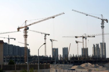 Giza, Egypt, June 6 2022: A construction site of new high rise in Egypt, new buildings construction in Giza developmental project with concrete, steel and crane towers, skyscrapers for residence