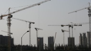 Giza, Egypt, June 6 2022: A construction site of new high rise in Egypt, new buildings construction in Giza developmental project with concrete, steel and crane towers, skyscrapers for residence