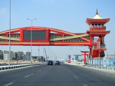 Cairo, Egypt, August 17 2022: Shinzo Abe axis patrol highway in Egypt with a pedestrian bridge finished in traditional Japanese architectural style, the traffic highway is named on former Japanese PM