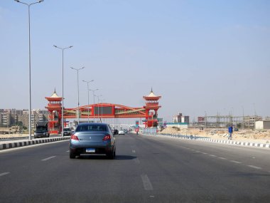Cairo, Egypt, August 17 2022: Shinzo Abe axis patrol highway in Egypt with a pedestrian bridge finished in traditional Japanese architectural style, the traffic highway is named on former Japanese PM
