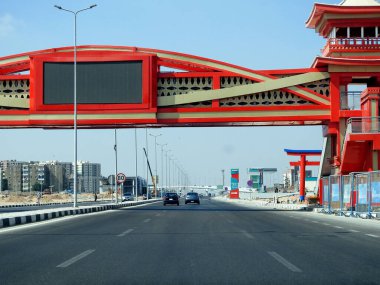 Cairo, Egypt, August 17 2022: Shinzo Abe axis patrol highway in Egypt with a pedestrian bridge finished in traditional Japanese architectural style, the traffic highway is named on former Japanese PM