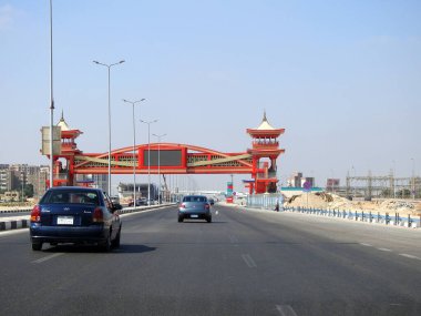 Cairo, Egypt, August 17 2022: Shinzo Abe axis patrol highway in Egypt with a pedestrian bridge finished in traditional Japanese architectural style, the traffic highway is named on former Japanese PM