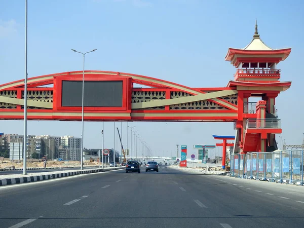 Cairo, Egypt, August 17 2022: Shinzo Abe axis patrol highway in Egypt with a pedestrian bridge finished in traditional Japanese architectural style, the traffic highway is named on former Japanese PM