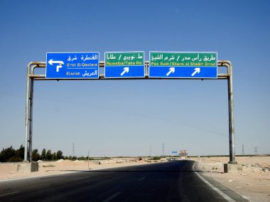 South Sinai, Egypt, August 12 2022: a direction sign board in South Sinai gives directions of Ras Sudr Sharm El Sheikh road, East El Qantara, El Arish, Nuweiba Taba road written in Arabic and English