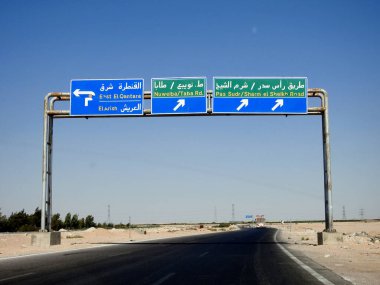 South Sinai, Egypt, August 12 2022: a direction sign board in South Sinai gives directions of Ras Sudr Sharm El Sheikh road, East El Qantara, El Arish, Nuweiba Taba road written in Arabic and English