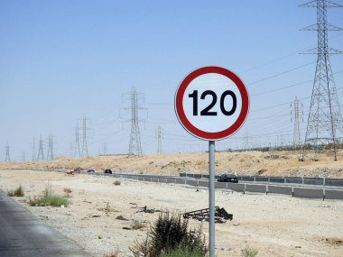 Cairo, Egypt, August 12 2022: 120 KM Speed limit sign in a free highway, one hundred twenty kilometers per hour traffic road sign, a restriction sign for car drivers not to exceed the set speed