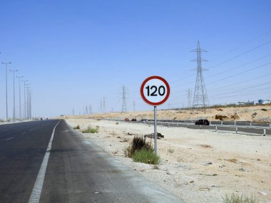 Cairo, Egypt, August 12 2022: 120 KM Speed limit sign in a free highway, one hundred twenty kilometers per hour traffic road sign, a restriction sign for car drivers not to exceed the set speed