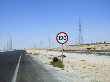 Cairo, Egypt, August 12 2022: 120 KM Speed limit sign in a free highway, one hundred twenty kilometers per hour traffic road sign, a restriction sign for car drivers not to exceed the set speed