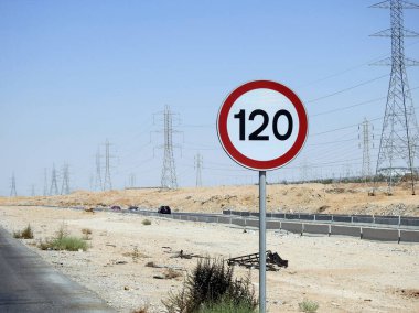 Cairo, Egypt, August 12 2022: 120 KM Speed limit sign in a free highway, one hundred twenty kilometers per hour traffic road sign, a restriction sign for car drivers not to exceed the set speed