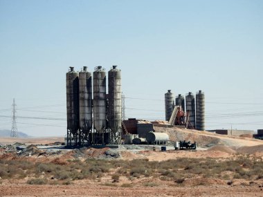 Suez, Egypt, August 12 2022: compact concrete batching plant equipment in the desert for production of asphalt, cement and concrete and mixing them for developmental purposes in roads and architecture