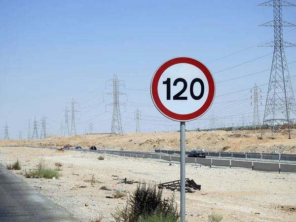 Cairo, Egypt, August 12 2022: 120 KM Speed limit sign in a free highway, one hundred twenty kilometers per hour traffic road sign, a restriction sign for car drivers not to exceed the set speed