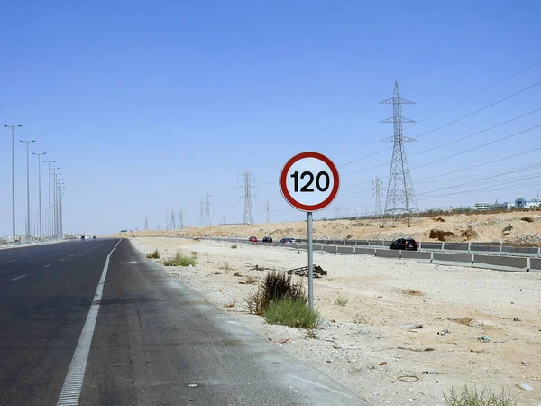 Cairo, Egypt, August 12 2022: 120 KM Speed limit sign in a free highway, one hundred twenty kilometers per hour traffic road sign, a restriction sign for car drivers not to exceed the set speed
