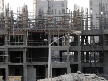 Giza, Egypt, August 20 2022: A construction site of a new high rise in Egypt new buildings under construction and skyscrapers with cranes, Egyptian new real estate developmental projects before sunset