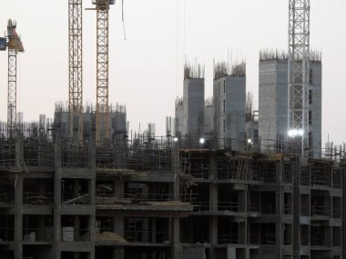Giza, Egypt, August 20 2022: A construction site of a new high rise in Egypt new buildings under construction and skyscrapers with cranes, Egyptian new real estate developmental projects before sunset