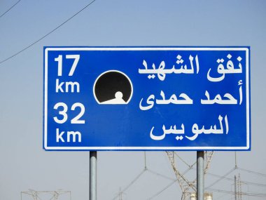Suez, Egypt, August 12 2022: a road sign board in Suez Cairo highway in Arabic, Translation (Martyr Ahmed Hamdi Tunnel 17 KM, Suez 32 KM), Ahmed Hamdy tunnel is a car tunnel under the Suez canal