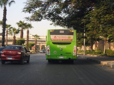 Cairo, Egypt, August 18 2022: A public transport Egyptian green bus on a highway, selective focus of a public transportation one level touring passengers' transit bus CTA Cairo Transportation