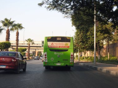 Cairo, Egypt, August 18 2022: A public transport Egyptian green bus on a highway, selective focus of a public transportation one level touring passengers' transit bus CTA Cairo Transportation