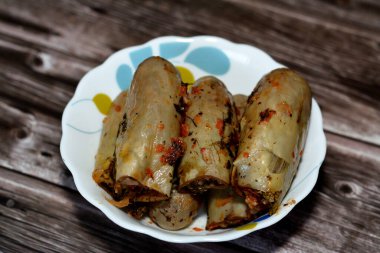 Eggplants Mahshi stuffed with white rice, onion, parsley, dill and coriander, selective focus of Arabic Egyptian traditional cuisine of white aubergine Mahshy filled with rice and cooked