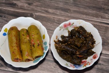 wrapped grape leaves and stuffed squash, courgette, marrow, mahshi, or zucchini filled with white rice, onion, parsley, dill and coriander, Arabic Egyptian traditional cuisine of Mahshy