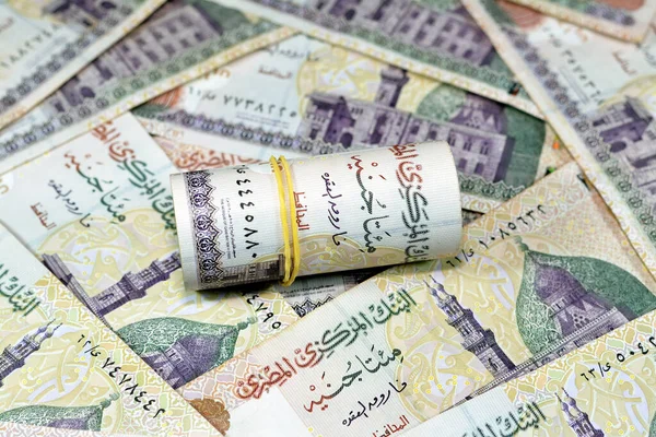 埃及面额为200埃及镑 橡皮筋为200埃及镑的钞票在卡尼湾清真寺的一堆埃及现金钞票上滚了出来 并有选择性地成为埃及货币的焦点 — 图库照片