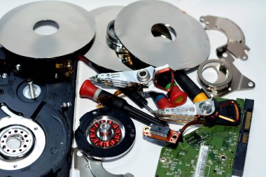 Diskleri olan hasarlı sabit disk sürücüsü bileşenleri, okuma başlığı, Milli motor, süspansiyon, pivot, ses bobini motor VCM, E-blok, veri parçası, tabaklar, kafa kolu, çalıştırıcı ve ana mantık çipi