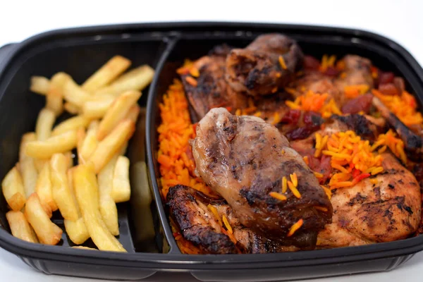 Barbecued chicken with long basmati rice and french fries, beef meat barbecued oriental tarb Kofta served with tomato dakos sauce, selective focus of Yemen recipe of Mandi chicken barbecued isolated