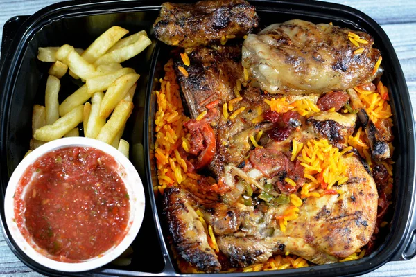 Barbecued chicken with long basmati rice and french fries, beef meat barbecued oriental tarb Kofta served with tomato dakos sauce, selective focus of Yemen recipe of Mandi chicken barbecued isolated