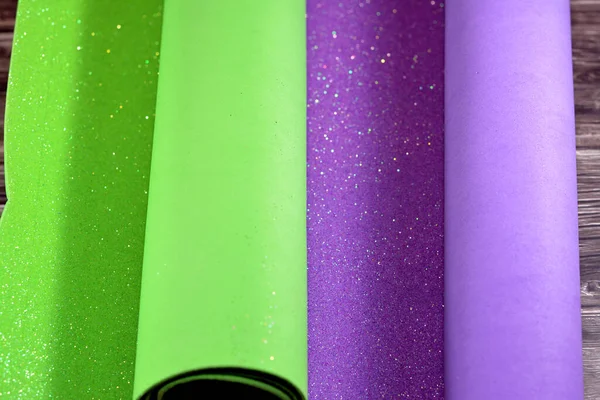 Rolls of glittered colorful Eva foam sheets, colored cardboard, rubber pad, sponge papers for school arts and crafts, pile of multicolored school board for children, back to school education concept