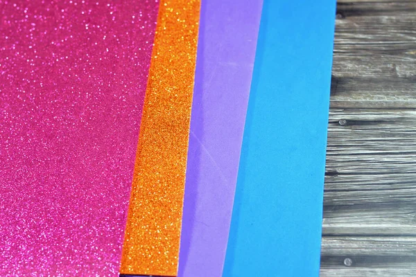 Glittered colorful Eva foam sheets, colored cardboard, rubber pad, sponge papers for school arts and crafts, pile of multicolored school board papers for children, back to school education concept