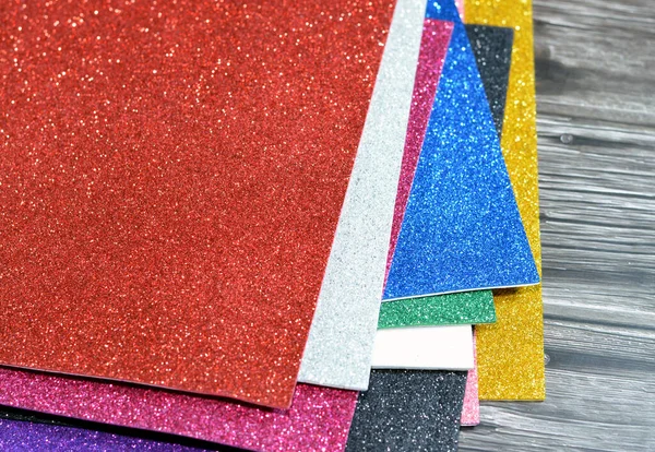 Glittered colorful Eva foam sheets, colored cardboard, rubber pad, sponge papers for school arts and crafts, pile of multicolored school board papers for children, back to school education concept