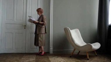 Office worker throws away documents and rejoices. Business woman throws up papers with reports and celebrates victory.