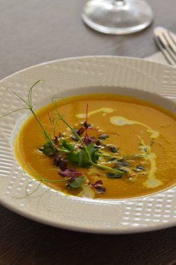 Sağlıklı kremalı sarı balkabağı çorbası otlu, restoranın arka planı öğle yemeği taze menü. 