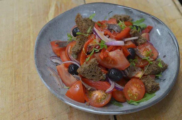 Tuscan Panzanella, traditional Italian salad with tomatoes and bread. Vegetarian panzanella salad. Mediterranean healthy food.