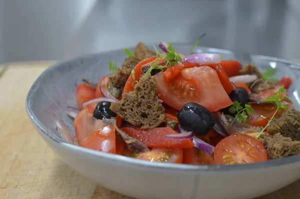 Tuscan Panzanella, traditional Italian salad with tomatoes and bread. Vegetarian panzanella salad. Mediterranean healthy food.