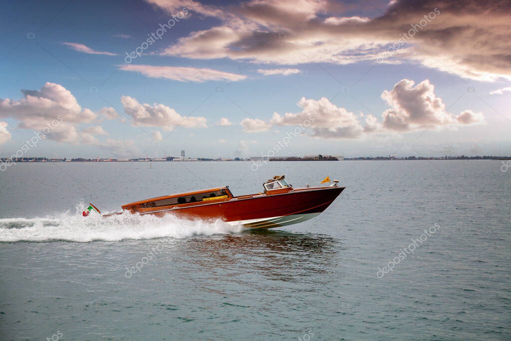 A taxi motorboat in the Venice lagoon transposed by tourists